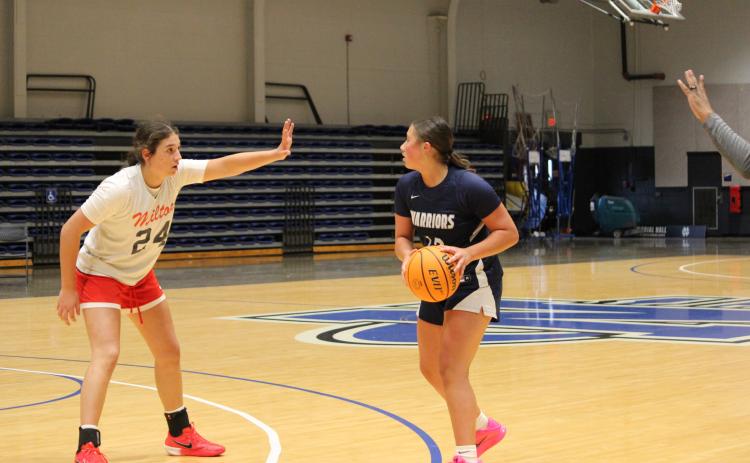 White County's Ansleigh Vandiver looks to make a pass during the Lady Warriors' game last week against Milton High School at the UNG Team Camp in Dahlonega. Vandiver hit a 3-pointer in the final seconds of regulation to send the game to sudden death overtime, but Milton scored on the first possession of OT to take a 54-52 win.   MARK TURNER/WCN