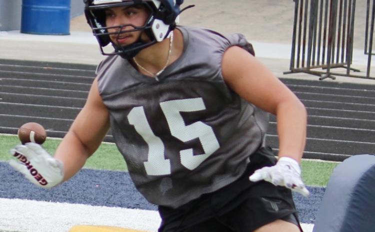 Casey Crane goes through a block drill during a linemen period.  MARK TURNER/WCN