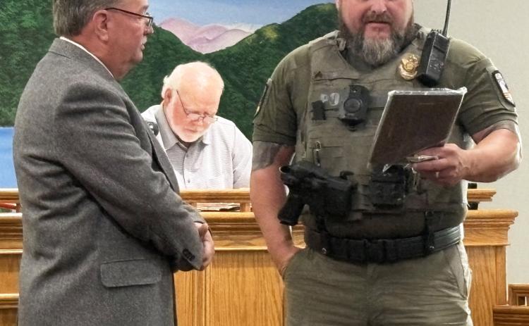 Sgt. Chris Barrett presents a retirement award to Officer William “Rice” Poteat during the June 16 City of Helen Commission meeting recognizing Poteat’s years of service with the Helen Police Department. CARLY HENDERSON/WCN
