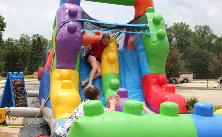 A cadet slides down an inflatable water slide during the White County Junior Law Enforcement Academy. The program includes physical training and team-building activities designed to introduce students to careers in law enforcement and public safety. PHOTOS BY CARLY HENDERSON/WCN