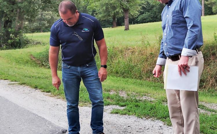 Commission Chairman Travis Turner and White County Manager Derick Canupp examine Garland Bristol Road in front of Fire Station No. 3. DENISE ETHERIDGE/WCN