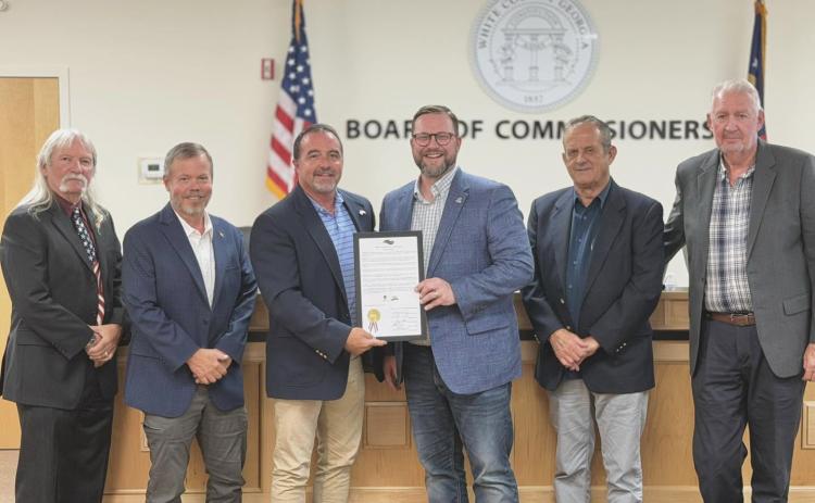On  Monday, the White County Commission presented Truett-McConnell University President Larry Lyon a proclamation honoring the school's 80th anniversary. From left: Commissioners Craig Bryant and Shan Ash, Chairman Traivs Turner, Lyon, and Commissioners Lyn Holcomb and Ed Nix. PHOTO BY BRYCE BARRETT
