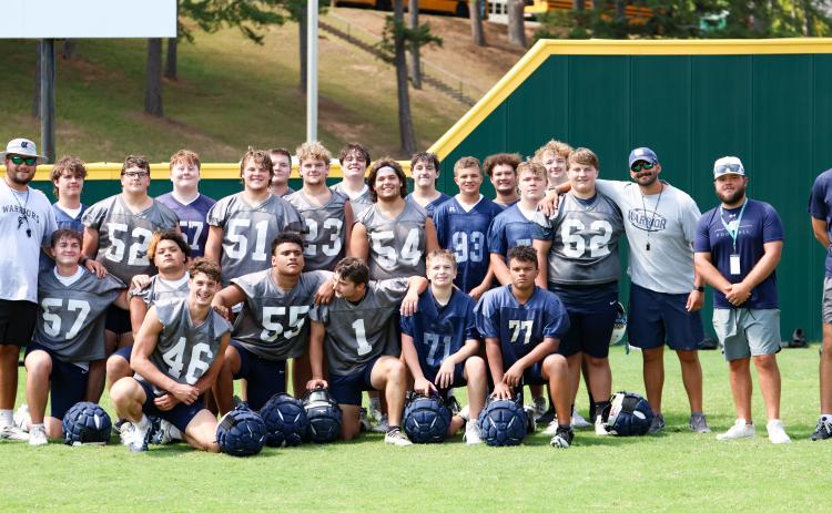 The Warriors' offensive and defensive line pose for a phot during the Fellowship of Christian Athlete's team camp last week at Piedmont University in Demorest.  JENNIFER KNIGHT/SPECIAL