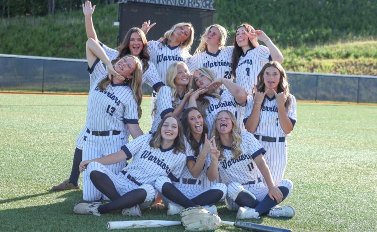 The members of the WCHS varsity softball team have a little fun during a photo shoot Monday afternoon at the WCHS complex . STACI SULHOFF/ SPECIAL