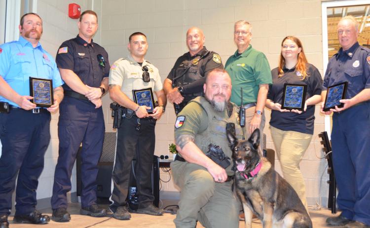 The White County Rotary Club presented awards to First Responders on Saturday, July 18. Kneeling in front is Helen Police Sgt. W. C. Barrett, handler for K-9 Zora. Standing, from left, are Cleveland Firefighter Will LaPree, Helen Fire Department Firefighter Hudson Anderson; White County Sheriff’s Deputy Michael Vice, Cleveland Police Officer David Bruce, Rotary President Phil Dodson, White County 911 Communications Officer Liberty Garrett, White County Firefighter Steve Hopper. See more photos on page 7A. L