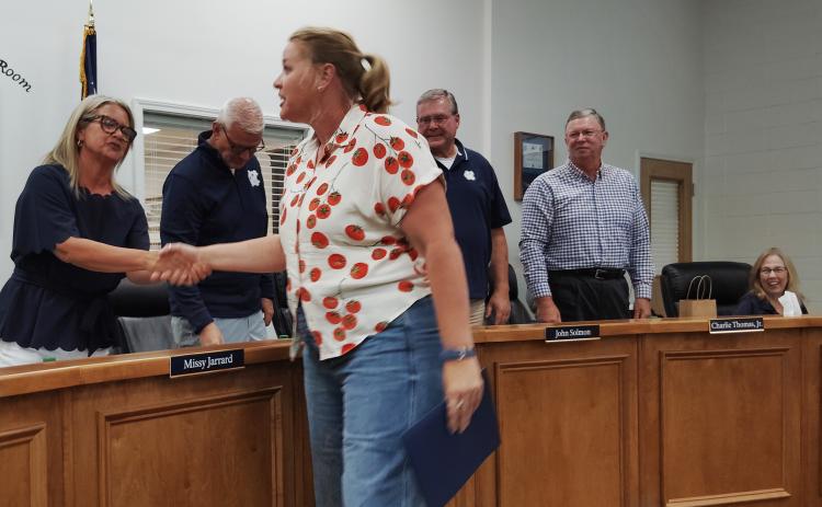 White County Middle School Agriculture teacher Meg Dickerson is congratulated by the White County Board of Education during a July 30 meeting. DENISE ETHERIDGE/WCN