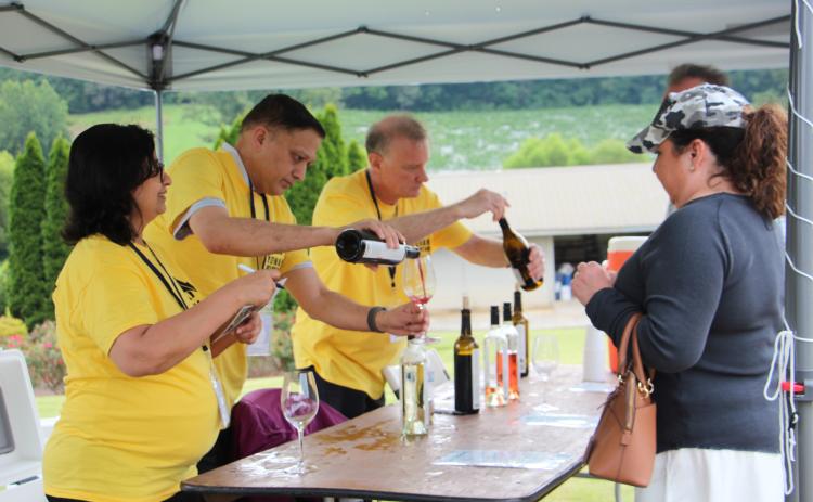 Yonah Mountain Vineyards staffers serve guests samples of wine at Crush Fest 2025. FILE PHOTO