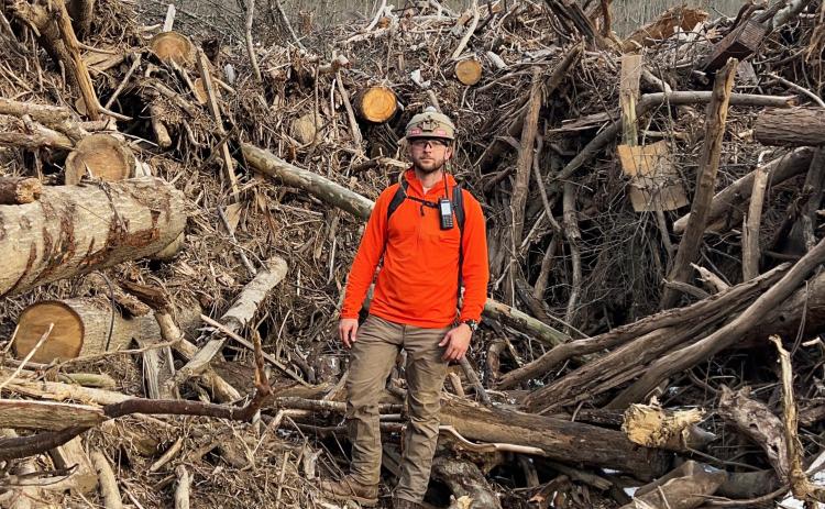 White County resident Michael Foley stands among storm debris during one of more than 60 helicopter missions he completed in western North Carolina following Hurricane Helene. Foley’s experiences during the missions later became the inspiration for “Scars on the Mountain,” a documentary about the storm’s impact on Yancey County residents. SUBMITTED PHOTO