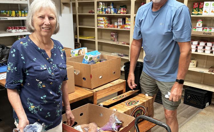 White County Food Pantry volunteers Pat Roland, left, and Richard Ingels put food boxes together for clients. SUBMITTED PHOTOS