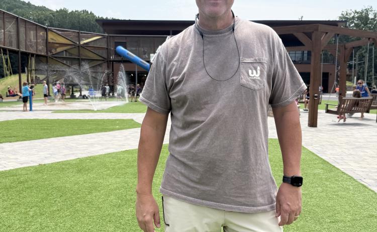 Camp Director Jon Estes stands in front of the new playground built for the elementary school-age camp at Woodlands. ERBELE/WCN