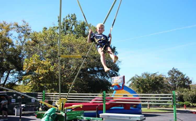 Eight-year-old Isaac jumps on a bungee during Truett McConnell's Community Fall Festival held last Saturday. CARLY HENDERSON/WCN