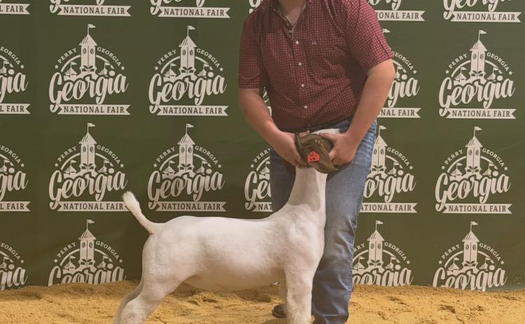 Bo Dodd stands with his goat following his win at the Georgia National Fair. SUBMITTED PHOTOS