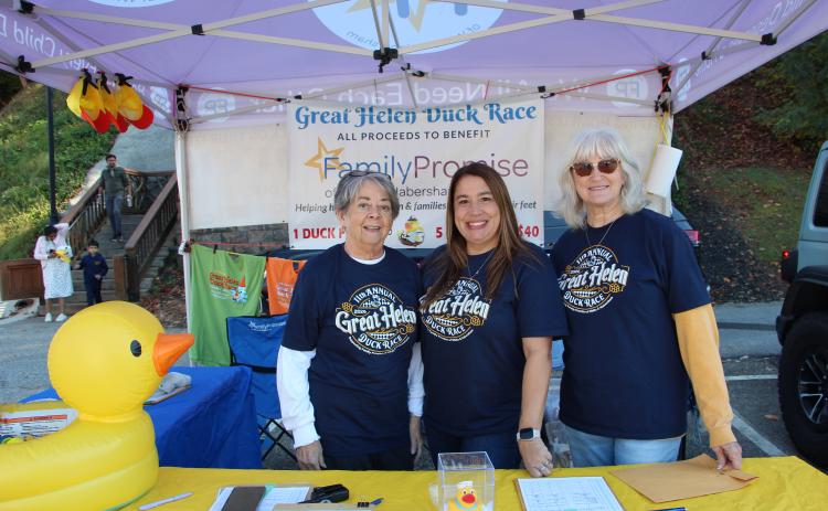 From left, Kathy Johnson, Martie Brooks and Cheryl Page encourage Oktoberfest attendees to participate in the Great Helen Duck Race. MAE SULLENS/WCN