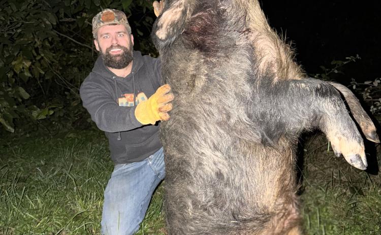 Jordan Dawson with the hog killed on Oct. 11. SUBMITTED PHOTO