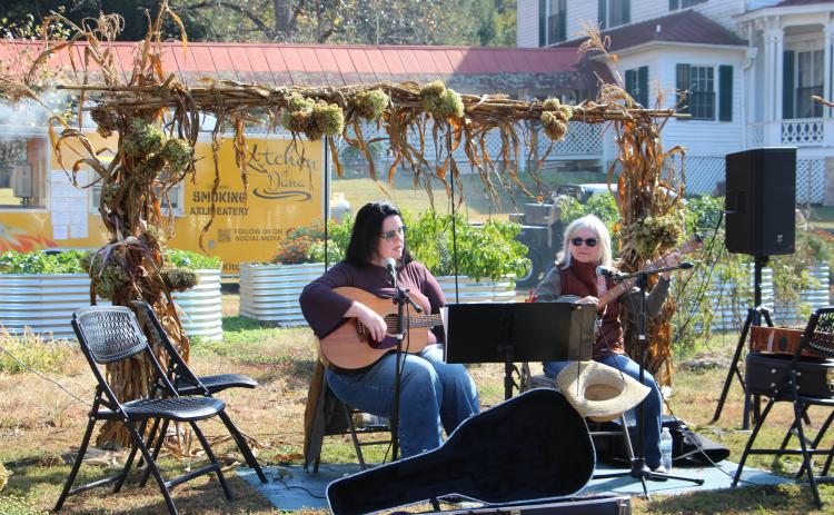 Sarah Ellen McDonald and Debbielee Whelchel play for visitors during the Mountain Farm Celebration at Hardman Farm State Historic Site last Saturday. PHOTOS BY MAE SULLENS/WCN