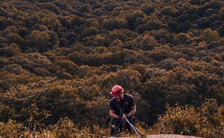 White County firefighter Will Roper prepares to repell down Mt. Yonah to reach a stranded climber during an Aug. 25 rescue. FILE PHOTO